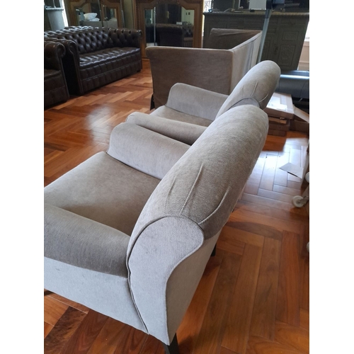 286 - A PAIR OF GREY UPHOLSTERED ARMCHAIRS, on turned leg with castors. Dimensions: 84cm wide x 82cm high ... 