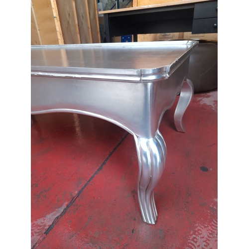 289 - A LARGE SILVER PAINTED COFFEE TABLE, with raised gallery border to top, raised on shaped fluted legs... 