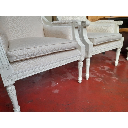 292 - A PAIR OF WHITE PAINTED FRENCH STYLE ARMCHAIRS, with upholstered backrest and seat, carved armrests ... 