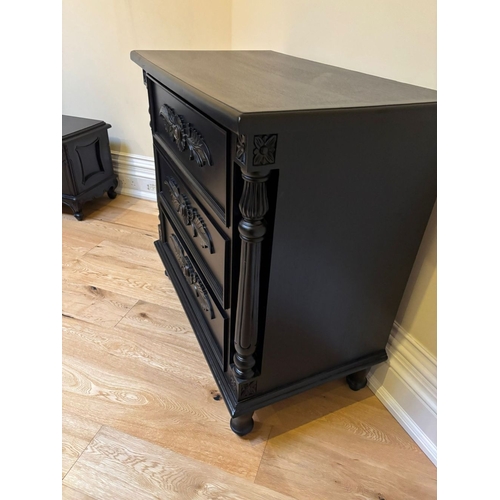 297 - A BLACK PAINTED THREE DRAWER CHEST OF DRAWERS, the three drawers with floral carved panels, between ... 