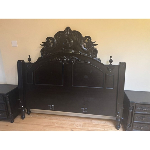 298 - A BLACK PAINTED CARVED HEADBOARD & FRAME, the headboard with carved mount to centre, between two fin... 