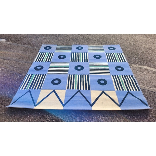 303 - A LARGE CONTEMPORARY FLOOR MAT/RUG, with geometric design, in good/fair condition, some ware and nee... 