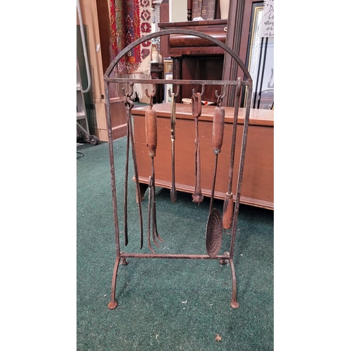 304 - AN ANTIQUE FIRE IRON STAND with various fire utensils. Including tongs, pan, hook and rake. Dimensio... 