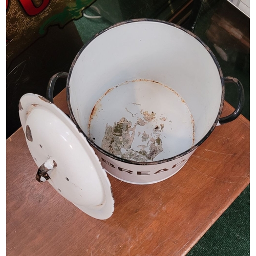 305 - AN ENAMEL BREAD CANISTER, with lid. The front of the tin with BREAD in bold lettering and a pair of ... 