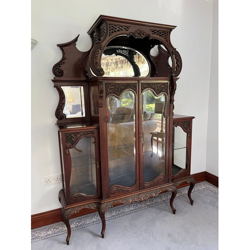 310 - A JACOBEAN STYLE GLAZED DISPLAY CABINET, with large oval mirror panelled back, above two smaller sha... 