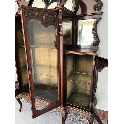 310 - A JACOBEAN STYLE GLAZED DISPLAY CABINET, with large oval mirror panelled back, above two smaller sha... 