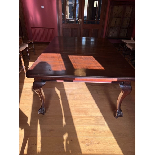 311 - A FINE MAHOGANY DINING TABLE, the top with canted corners, raised on cabriole leg on claw and ball f... 