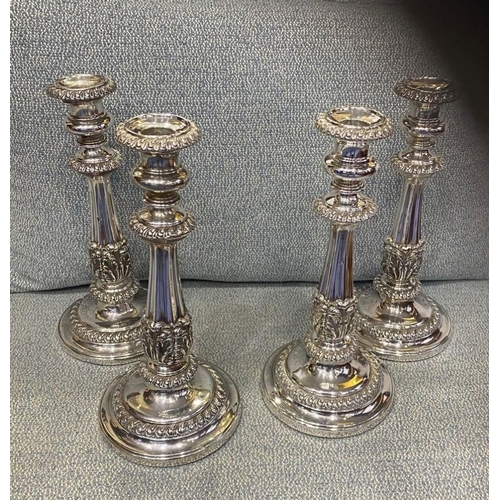 327 - A SET OF FOUR GEORGE IV SILVER CANDLESTICKS, by S Young & Co., Sheffield c.1823. Each features decor... 