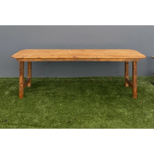 329 - A LARGE PINE TRESTLE TABLE, long rectangular top with canted corners, raised on four straight legs j... 