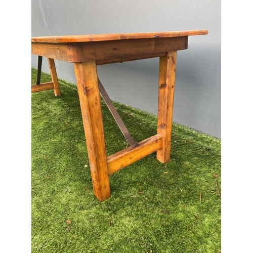 329 - A LARGE PINE TRESTLE TABLE, long rectangular top with canted corners, raised on four straight legs j... 