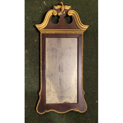 47 - A CHIPPENDALE STYLE GILT WOOD WALL MIRROR, with scroll shaped pediment to the top having a central e... 