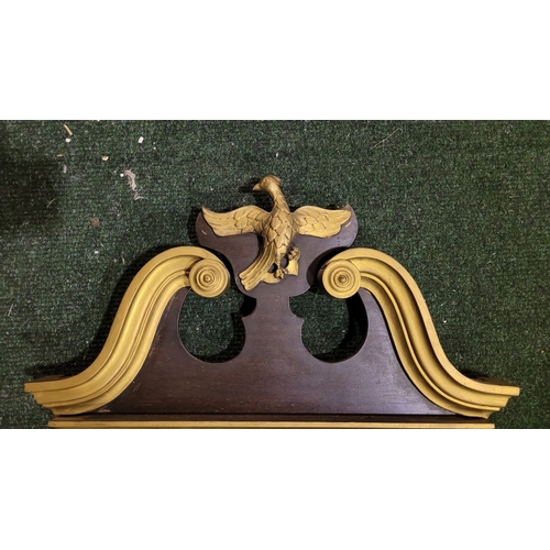 47 - A CHIPPENDALE STYLE GILT WOOD WALL MIRROR, with scroll shaped pediment to the top having a central e... 