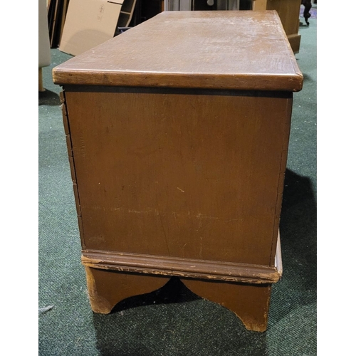 48 - AN OLD WOODEN BLANKET CHEST BOX, with hinged lid, raised on bracket feet. Top opens to reveal storag... 