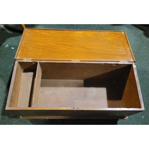 48 - AN OLD WOODEN BLANKET CHEST BOX, with hinged lid, raised on bracket feet. Top opens to reveal storag... 