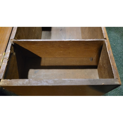 48 - AN OLD WOODEN BLANKET CHEST BOX, with hinged lid, raised on bracket feet. Top opens to reveal storag... 