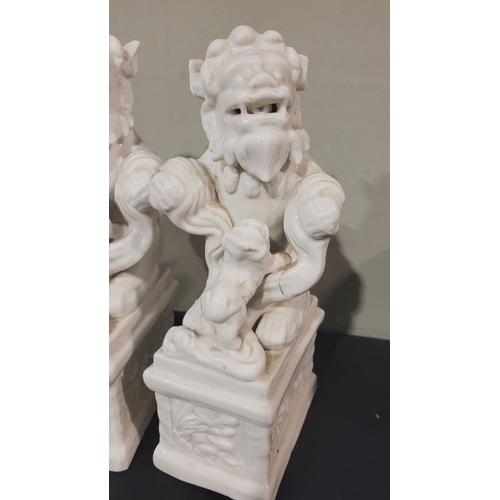 49 - TWO VINTAGE ‘BLANC DE CHINE’ FOO DOGS / GUARDIAN LIONS, both lions are seated upon a plinth base tha... 