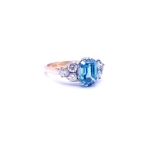 5 - A STUNNING 18CT YELLOW GOLD AQUAMARINE & DIAMOND RING, to the centre is a large emerald cut aquamari... 