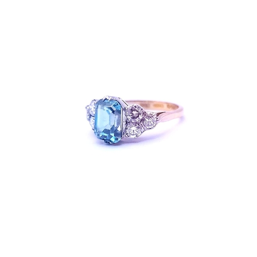 5 - A STUNNING 18CT YELLOW GOLD AQUAMARINE & DIAMOND RING, to the centre is a large emerald cut aquamari... 