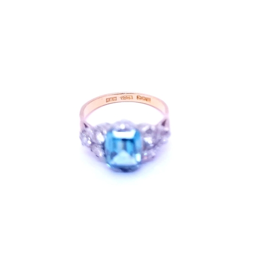 5 - A STUNNING 18CT YELLOW GOLD AQUAMARINE & DIAMOND RING, to the centre is a large emerald cut aquamari... 