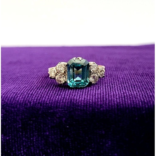 5 - A STUNNING 18CT YELLOW GOLD AQUAMARINE & DIAMOND RING, to the centre is a large emerald cut aquamari... 