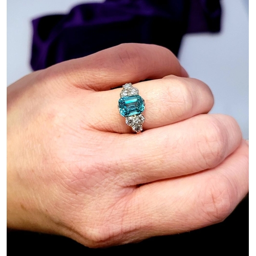 5 - A STUNNING 18CT YELLOW GOLD AQUAMARINE & DIAMOND RING, to the centre is a large emerald cut aquamari... 