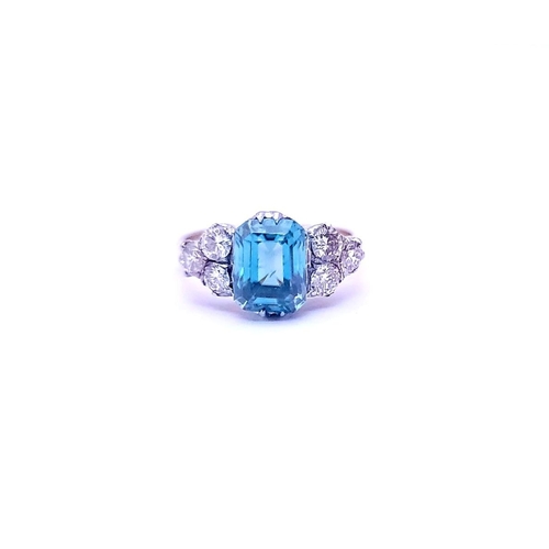 5 - A STUNNING 18CT YELLOW GOLD AQUAMARINE & DIAMOND RING, to the centre is a large emerald cut aquamari... 