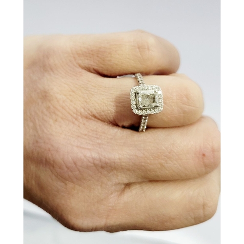 50 - A GOOD PLATINUM DIAMOND HALO RING, with a radiant cut diamond to the centre, surrounded by a frame o... 