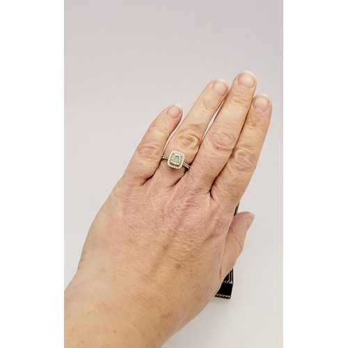 50 - A GOOD PLATINUM DIAMOND HALO RING, with a radiant cut diamond to the centre, surrounded by a frame o... 