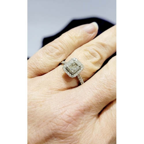 50 - A GOOD PLATINUM DIAMOND HALO RING, with a radiant cut diamond to the centre, surrounded by a frame o... 