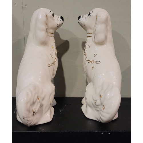 51 - A PAIR OF IRISH SHANNONBRIDGE POTTERY MANTLE DOGS, each with a painted face & gilt chain detail, mak... 