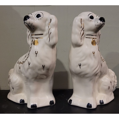 51 - A PAIR OF IRISH SHANNONBRIDGE POTTERY MANTLE DOGS, each with a painted face & gilt chain detail, mak... 