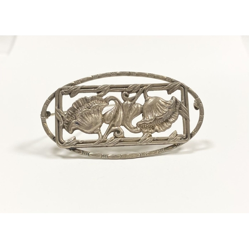 62 - A BEAUTIFUL ART NOUVEAU STERLING SILVER FLOWER BROOCH, featuring two flowers within openwork rectang... 