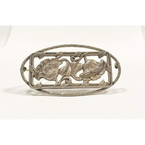 62 - A BEAUTIFUL ART NOUVEAU STERLING SILVER FLOWER BROOCH, featuring two flowers within openwork rectang... 