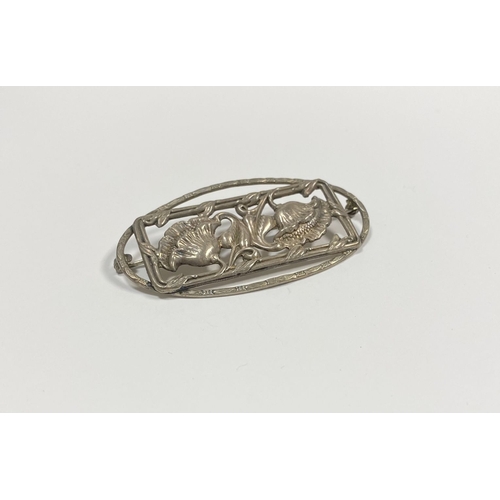 62 - A BEAUTIFUL ART NOUVEAU STERLING SILVER FLOWER BROOCH, featuring two flowers within openwork rectang... 