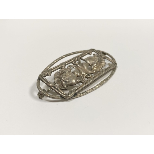 62 - A BEAUTIFUL ART NOUVEAU STERLING SILVER FLOWER BROOCH, featuring two flowers within openwork rectang... 