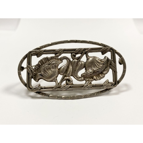 62 - A BEAUTIFUL ART NOUVEAU STERLING SILVER FLOWER BROOCH, featuring two flowers within openwork rectang... 