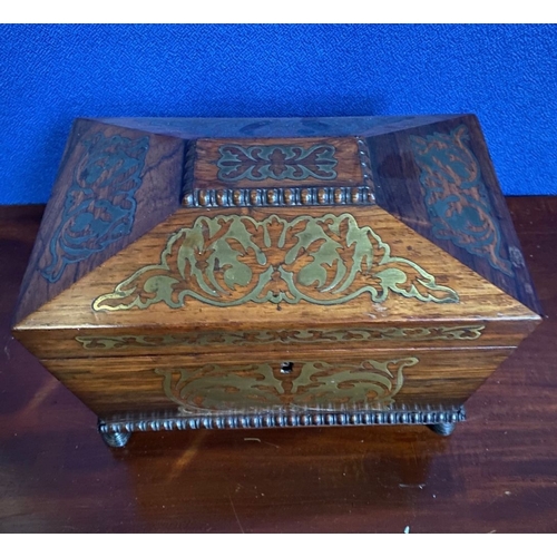 64 - A REGENCY ROSEWOOD BRASS INLAID JEWELLERY BOX, sarcophagus form, with carving to raised centre and b... 