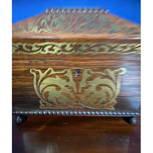 64 - A REGENCY ROSEWOOD BRASS INLAID JEWELLERY BOX, sarcophagus form, with carving to raised centre and b... 