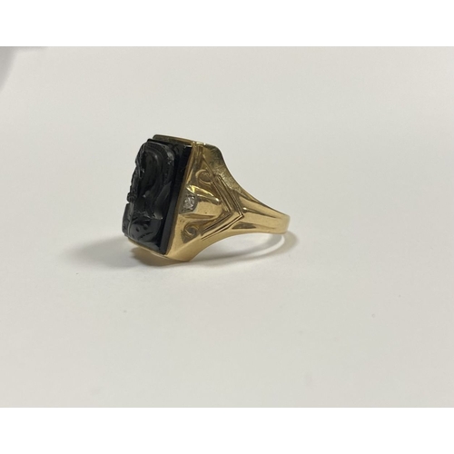 66 - AN EXCELLENT GOLD, DIAMOND & CARVED BLACK ONYX INTAGLIO SIGNET RING, with rectangular carved black o... 