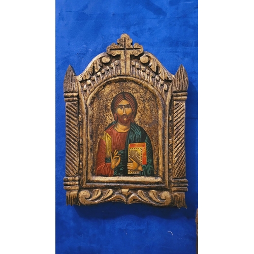 74 - A PAIR OF HAND PAINTED CARVED RELIGIOUS ICONOGRAPHIC PANELS, the frame with gilt colouring & carved ... 