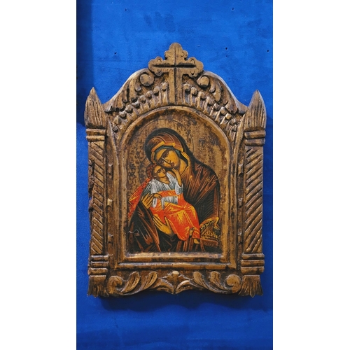 74 - A PAIR OF HAND PAINTED CARVED RELIGIOUS ICONOGRAPHIC PANELS, the frame with gilt colouring & carved ... 