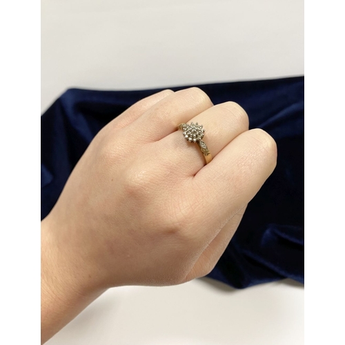 76 - A BEAUTIFUL 9CT YELLOW GOLD DIAMOND CLUSTER RING, with central round cut diamond surrounded by two r... 