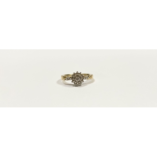 76 - A BEAUTIFUL 9CT YELLOW GOLD DIAMOND CLUSTER RING, with central round cut diamond surrounded by two r... 