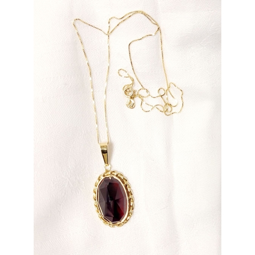 79 - AN ATTRACTIVE 14CT YELLOW GOLD GARNET PENDANT NECKLACE, lovely delicate link chain holds the oval sh... 