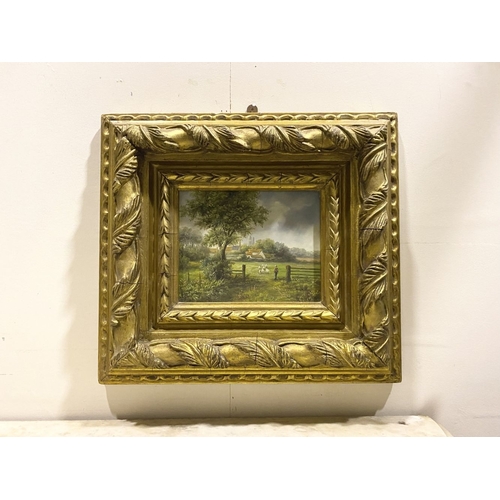 8 - AN EARLY 20TH CENTURY RURAL LANDSCAPE IN HIGHLY DECORATIVE GILT FRAME, oil on board, depicting rural... 