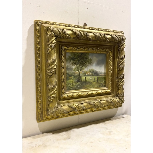 8 - AN EARLY 20TH CENTURY RURAL LANDSCAPE IN HIGHLY DECORATIVE GILT FRAME, oil on board, depicting rural... 