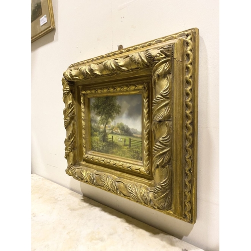 8 - AN EARLY 20TH CENTURY RURAL LANDSCAPE IN HIGHLY DECORATIVE GILT FRAME, oil on board, depicting rural... 