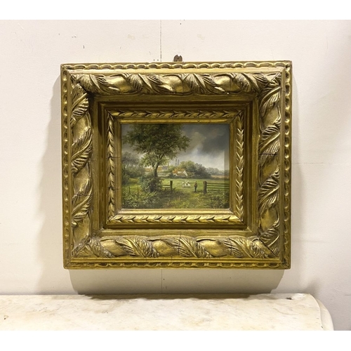 8 - AN EARLY 20TH CENTURY RURAL LANDSCAPE IN HIGHLY DECORATIVE GILT FRAME, oil on board, depicting rural... 