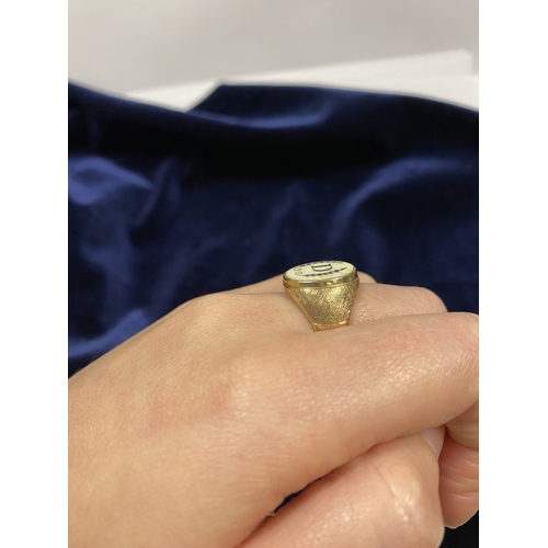 87 - A 14CT YELLOW GOLD ‘D’ ENGRAVED SIGNET RING, with central oval inset carved ‘D’ between fleur de lis... 