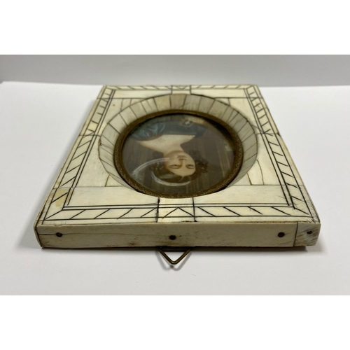 11 - A FRAMED 19TH CENTURY MINIATURE PORTRAIT, framed in a ‘Piano Key’ bone frame, with oval brass border... 